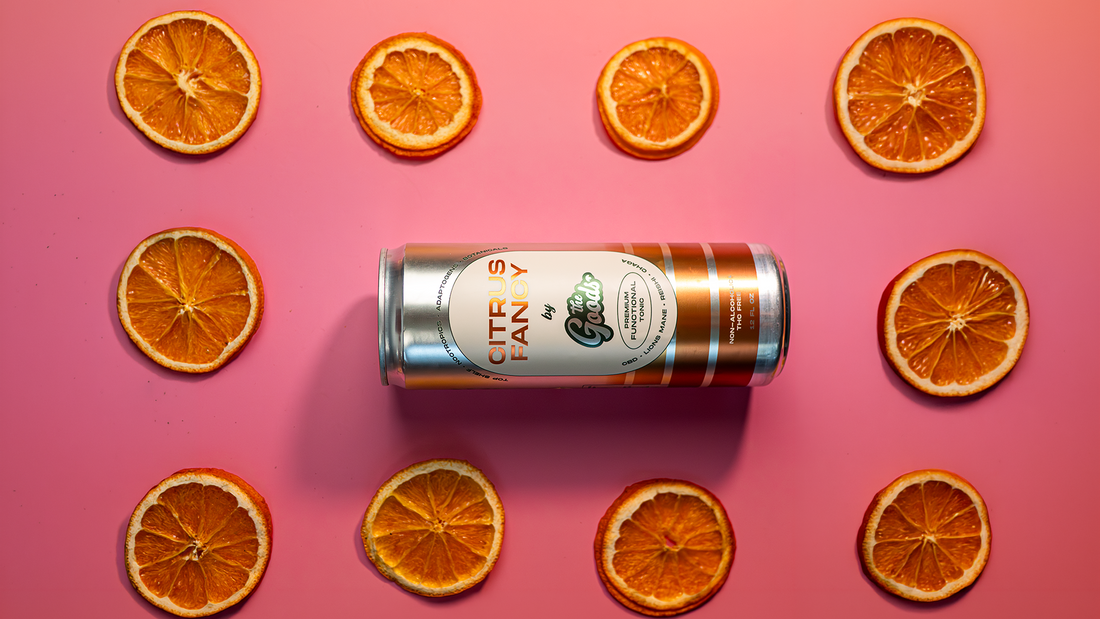 a can of Citrus Fancy Functional Tonic in front of a pink background