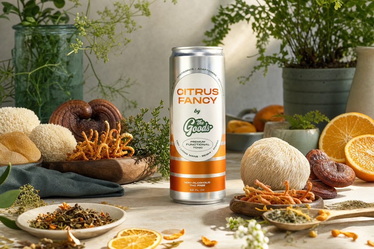 Citrus Fancy functional tonic can surrounded by lion's mane, reishi, cordyceps mushrooms, orange slices, and herbs.