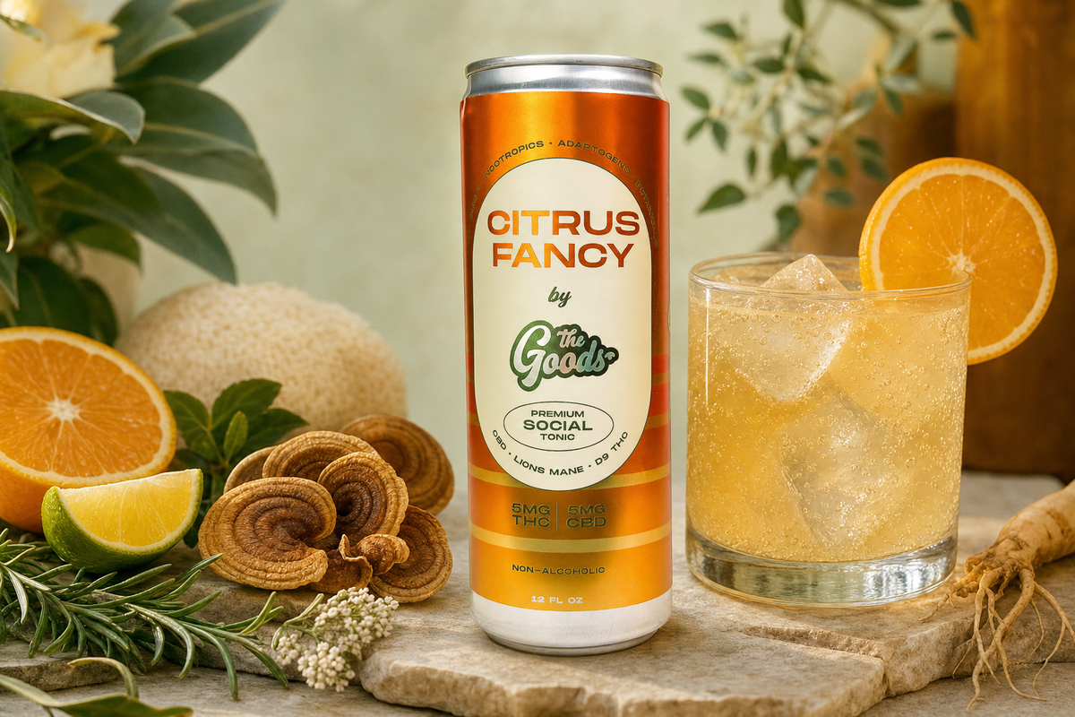 Citrus Fancy social tonic can beside a glass of iced drink with orange slice, mushrooms, citrus, and herbs.