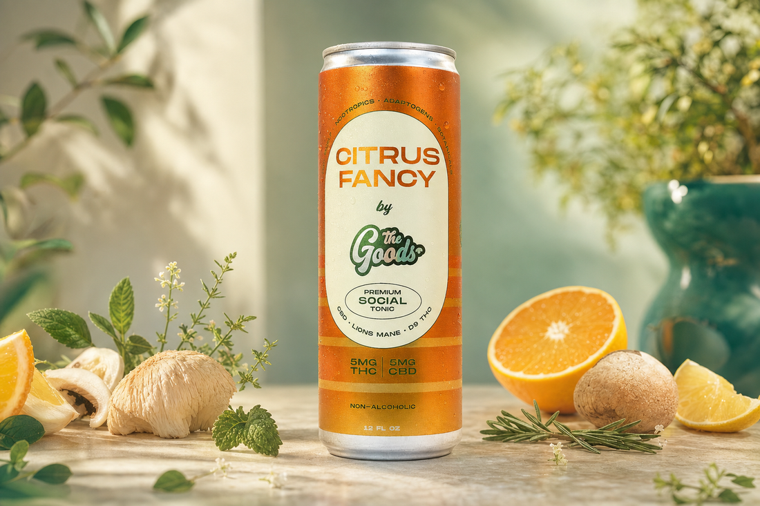 Orange "Citrus Fancy" by The Goods tonic can with 5mg THC/CBD, surrounded by citrus, mushrooms, and herbs.
