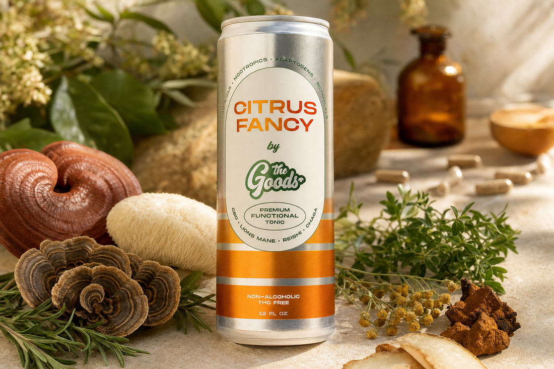 Citrus Fancy functional tonic can surrounded by medicinal mushrooms, herbs, capsules, and an amber apothecary bottle.