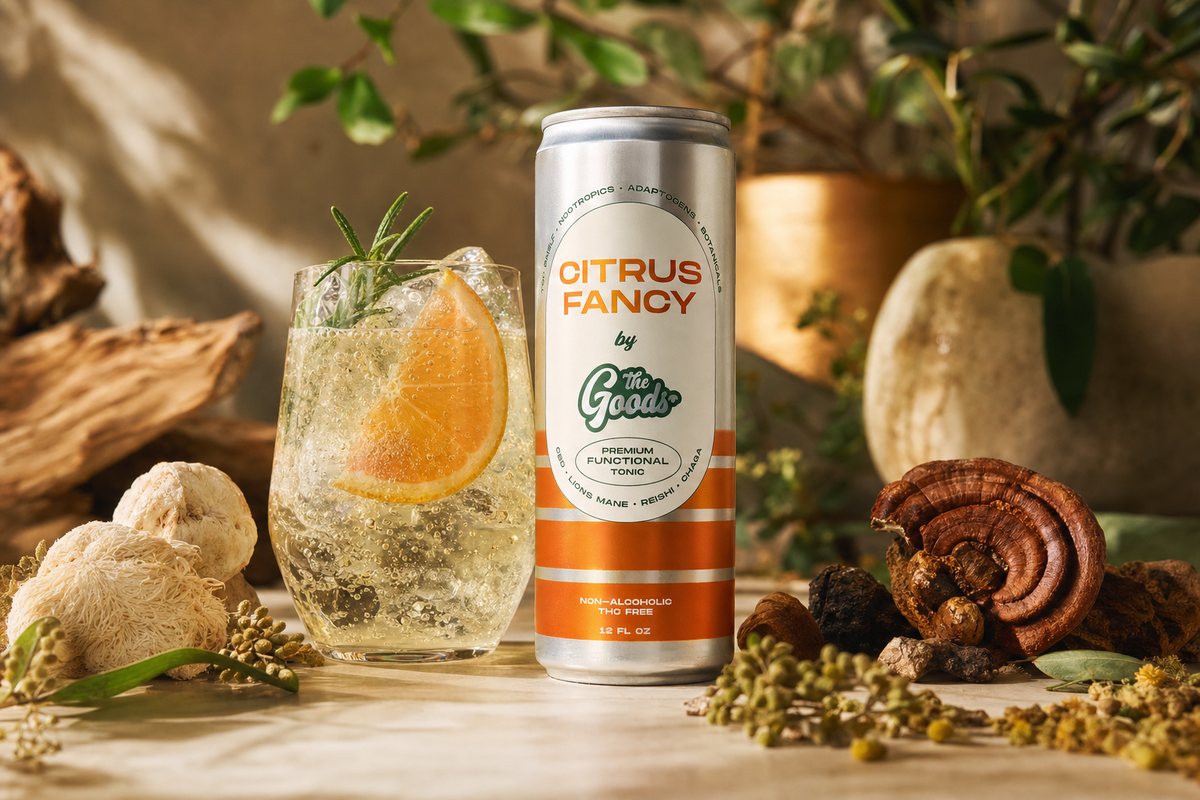 Citrus Fancy functional tonic can beside a garnished drink, surrounded by mushrooms and botanicals.