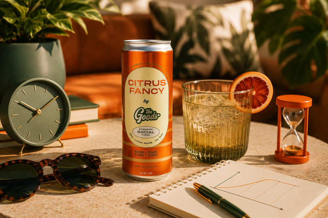 Can of 'Citrus Fancy' soda on a table with a glass, sunglasses, and other items.