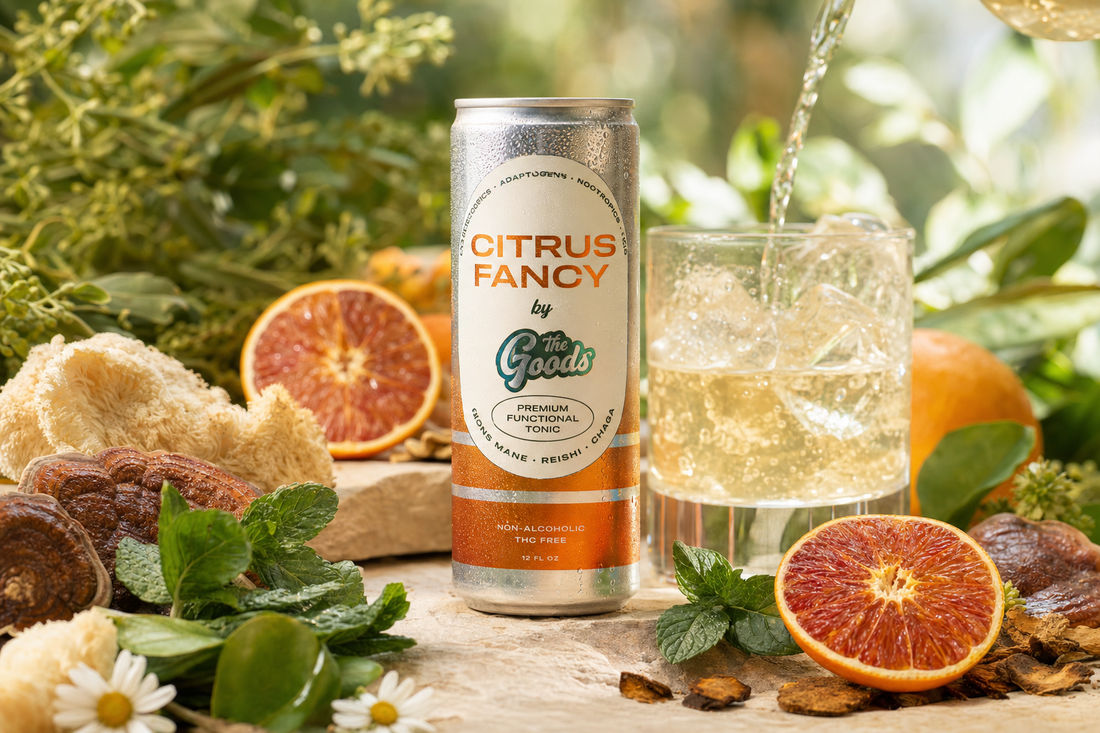 Citrus Fancy functional tonic can beside a poured drink, blood oranges, mint, and mushrooms amid greenery.