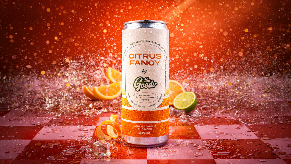 a can of citrus fancy functional beverage in front of a red background with fruit slices